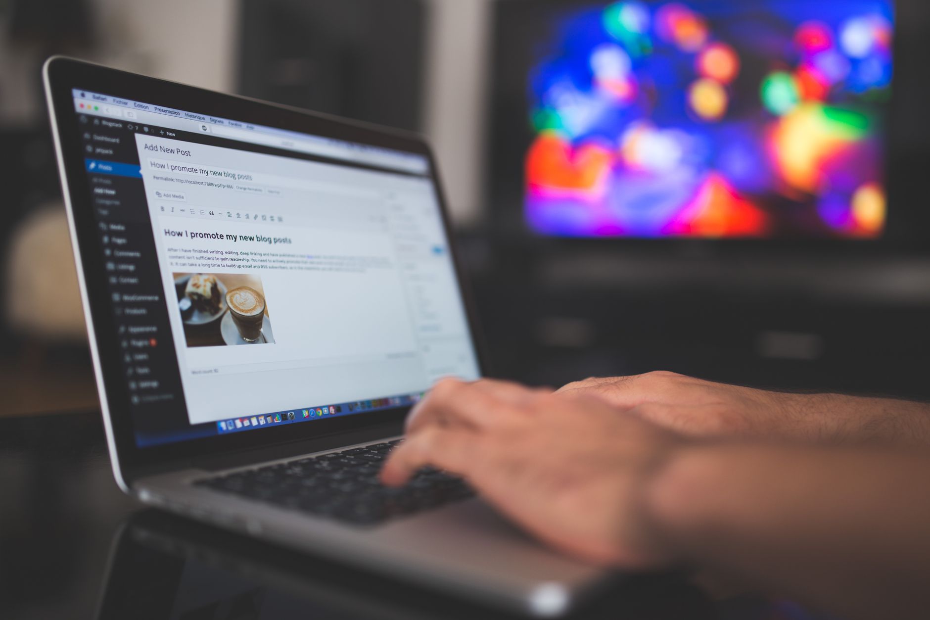Hands typing on a laptop with a blog post open on screen