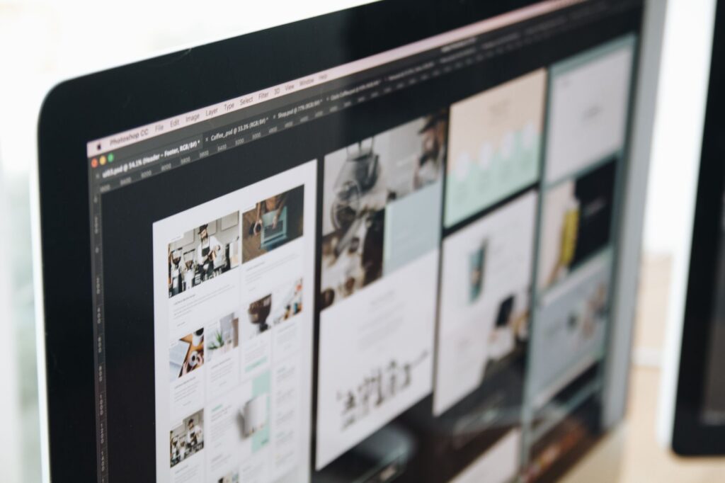 Computer screen displaying a web design project in a modern workspace